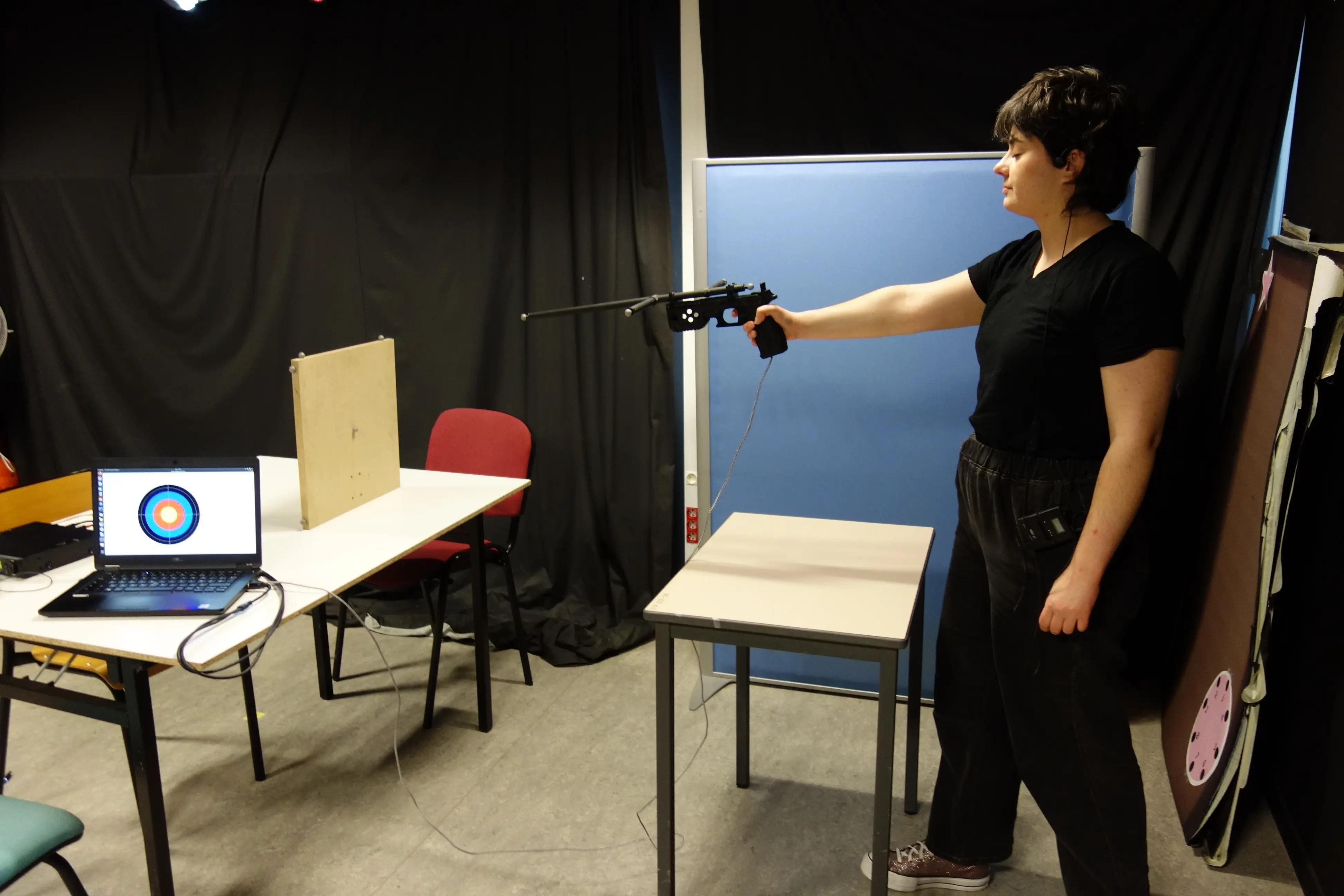 Chercheuse utilisant un pistolet sur cible, représentant le Laser-Run
